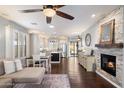 Open floor plan showcasing living room with fireplace, dining area, and kitchen with stainless steel appliances at 7428 W Montgomery Rd, Peoria, AZ 85383