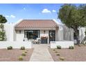 Charming single-story home with a red tile roof, a cozy front patio, and drought-resistant landscaping at 8405 N Via Mia --, Scottsdale, AZ 85258