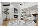 Inviting living room featuring a stone fireplace, vaulted ceilings, and contemporary decor, with views to adjacent rooms at 8405 N Via Mia --, Scottsdale, AZ 85258