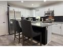 Modern kitchen featuring stainless steel appliances, granite countertops, a kitchen island and white cabinetry at 872 W Desert Sky Dr, San Tan Valley, AZ 85143