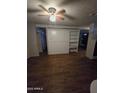 View of a living room featuring built-in shelving and a Murphy bed for convenient space saving at 8727 N 35Th Dr, Phoenix, AZ 85051