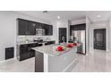 Modern kitchen with stainless steel appliances, island, granite countertops, and dark-stained cabinets at 8836 S 165Th Ave, Goodyear, AZ 85338