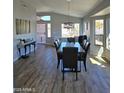 Well lit dining room featuring wood floors, large windows, and an open floor plan at 8965 E Red Mountain Ln, Gold Canyon, AZ 85118