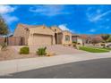 Well-maintained single-story home with a desert landscape, two-car garage, and a beautifully paved driveway at 9302 W White Feather Ln, Peoria, AZ 85383