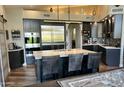 Modern kitchen features a large island with seating, stainless steel appliances, and sleek cabinetry at 11945 N 83Rd Pl, Scottsdale, AZ 85260