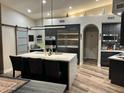 Modern kitchen features a large island with seating, stainless steel appliances, and sleek cabinetry at 11945 N 83Rd Pl, Scottsdale, AZ 85260