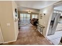 Inviting living room with tiled floor, opening to a cozy sitting area with comfortable furnishings at 12702 W Ashwood Dr, Sun City West, AZ 85375