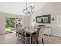 Bright dining area with a modern chandelier and slider access to the backyard at 1501 N Lesueur --, Mesa, AZ 85203