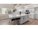 Bright kitchen features white cabinetry, a large island with seating, and stainless steel appliances at 1501 N Lesueur --, Mesa, AZ 85203