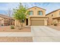 Two-story home features a well-manicured lawn, desert landscaping, and a spacious two-car garage at 17176 W Molly Ln, Surprise, AZ 85387