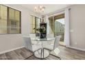 Bright dining room showcasing a glass table, four white chairs, and sliding door with an exterior view at 1756 E Bridgeport Pkwy, Gilbert, AZ 85295