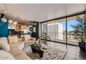 Spacious living room features tile floors, comfortable seating, and large windows with city views at 207 W Clarendon Ave # G18, Phoenix, AZ 85013