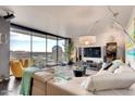 Bright living room with floor to ceiling windows, comfortable seating, and views of the city at 207 W Clarendon Ave # G18, Phoenix, AZ 85013