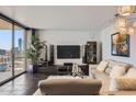 This living room offers city views, tile floors, and sleek modern decor for comfortable living at 207 W Clarendon Ave # G18, Phoenix, AZ 85013