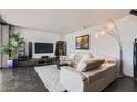 Bright living room with tile floors, modern lighting, and comfortable seating creating a cozy atmosphere at 207 W Clarendon Ave # G18, Phoenix, AZ 85013