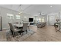 Open-concept living space with a modern dining table and comfortable seating area at 20718 W Colter St, Buckeye, AZ 85396