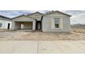 Charming single-story home with an attached two-car garage, neutral stucco, and wood accents at 22677 E Saddle Way, Queen Creek, AZ 85142