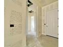 Hallway featuring high ceilings, white walls, and visible framework awaiting completion and customization at 22677 E Saddle Way, Queen Creek, AZ 85142