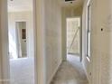 Hallway exhibiting unfinished walls, trim work, and multiple doorways, setting the stage for customization at 22677 E Saddle Way, Queen Creek, AZ 85142