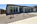 Attractive single-story home featuring minimal landscaping and a gray driveway at 22685 E Saddle Way, Queen Creek, AZ 85142