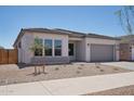 Attractive single-story home with desert landscaping, neutral colors, and a two-car garage at 22685 E Saddle Way, Queen Creek, AZ 85142