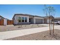 Inviting single-story home featuring desert landscaping, a neutral color palette, and a two-car garage at 22685 E Saddle Way, Queen Creek, AZ 85142