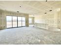 Unfinished large living space with a sliding glass door opening onto the patio area at 22693 E Saddle Way, Queen Creek, AZ 85142