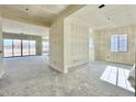 Unfinished living area with drywall and large sliding glass doors leading to the backyard at 22693 E Saddle Way, Queen Creek, AZ 85142