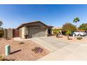 Property showcasing a well-maintained desert landscape, a wide driveway, and a two-car garage at 33224 N Cat Hills Ave, San Tan Valley, AZ 85144