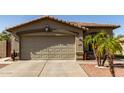 Exterior of a single-Gathering house featuring a two-car garage, desert landscaping, and tiled roof at 33224 N Cat Hills Ave, San Tan Valley, AZ 85144