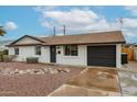 Charming single-story home with a well-maintained front yard and a tidy rock garden feature at 3520 E Ludlow Dr, Phoenix, AZ 85032