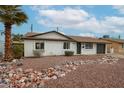 Charming single-story home with a well-maintained front yard and a tidy rock garden feature at 3520 E Ludlow Dr, Phoenix, AZ 85032