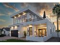 Elegant two-story home boasts a modern design, balcony, outdoor fireplace, and desert landscaping at 4120 N 44Th Pl, Phoenix, AZ 85018