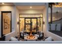 Inviting outdoor firepit area with modern seating and views of the home's interior at 4120 N 44Th Pl, Phoenix, AZ 85018
