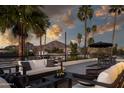 Outdoor living area with comfortable seating, string lights, and scenic mountain views at sunset at 4120 N 44Th Pl, Phoenix, AZ 85018