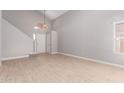 Bright living room with vaulted ceilings, light wood flooring, and ample natural light from a large window at 4714 E Angela Dr, Phoenix, AZ 85032