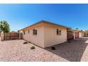 Tan ranch home with desert landscaping and block fence at 6305 E Adobe Rd, Mesa, AZ 85205