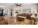 Bright living room featuring wood floors, neutral walls, and a ceiling fan at 6305 E Adobe Rd, Mesa, AZ 85205
