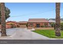 Charming single-story brick home featuring a well-manicured lawn, covered porch and a detached garage at 6314 N 14Th Pl, Phoenix, AZ 85014