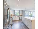 Modern kitchen featuring stainless steel appliances, sleek white cabinetry, and a large central island at 6502 N Central Ave # A103, Phoenix, AZ 85012