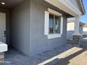 Inviting covered entryway featuring stone accents and a window with white trim adding architectural interest at 7694 W Saddlehorn Rd, Peoria, AZ 85383