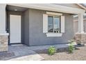 Close up of front door with white shutters and front porch landscaping at 7701 W Avenida Del Rey --, Peoria, AZ 85383