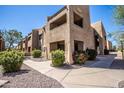 View of a building with a balcony, showing its architectural style and surrounding landscape at 8155 E Roosevelt St # 231, Scottsdale, AZ 85257