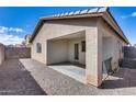 Covered back patio with desert landscaping, creating an outdoor living space at 849 E Impreria St, San Tan Valley, AZ 85140