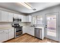 Bright kitchen featuring white cabinets, stainless steel appliances, and a view to the backyard at 849 E Impreria St, San Tan Valley, AZ 85140