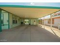 Spacious carport with concrete flooring and access to the home's sliding glass doors and utility entrance at 8500 E Southern Ave # 447, Mesa, AZ 85209