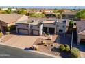 Stunning aerial view of a single-story home, showcasing the desert landscaping and brick driveway at 8541 E Canyon Estates Cir, Gold Canyon, AZ 85118