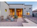 Inviting front entrance of a home, with a wooden front door and desert landscaping at 8541 E Canyon Estates Cir, Gold Canyon, AZ 85118