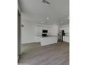 Bright and modern kitchen with white cabinets, stainless steel appliances and island at 9327 E Static Ave, Mesa, AZ 85212