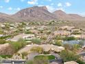 An aerial shot reveals a luxury property in a desert setting, framed by majestic mountains at 9513 N 129Th Pl, Scottsdale, AZ 85259